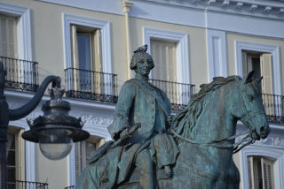 Estatua ecuestre de Carlos III.  Una paloma reposa sobre
             la cabeza.